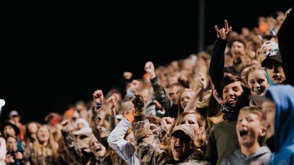 fans cheering in a crowded space